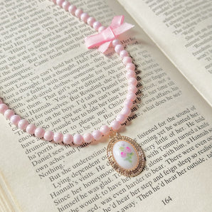 Put ribbon on my pink pearl necklace~